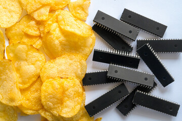 Microchips and potato chips conceptually contrast the intersection of technology and food, highlighting innovation and simplicity in modern life.