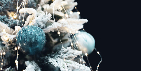 New Year's decor. Christmas background with decorative balls on a Christmas tree branch, soft selective focus, toned	
