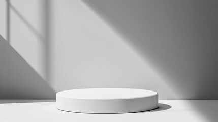 Fototapeta premium Minimalist round pedestal in a bright room showcasing light and shadow patterns during the day