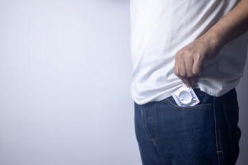 The man pulled out a condom from his pants pocket and stood there.