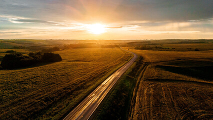 the car is driving along a beautiful road