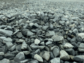 Gray and white crushed stone for decorating and increasing the height of the front surface of the house.