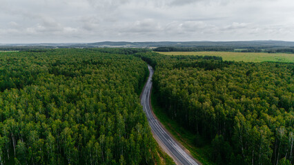 the car is driving along a beautiful road
