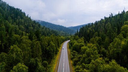 the car is driving along a beautiful road