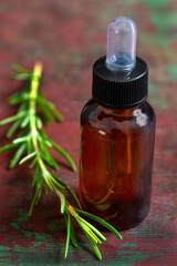 organic cosmetics with herbal extracts of taragon oil on wooden background