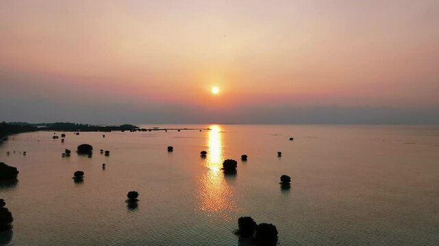 Aerial view of tropical beach and island at sunset, pari island north jakarta, indonesia
