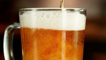 Close-up of beer pouring into pint , freeze motion.