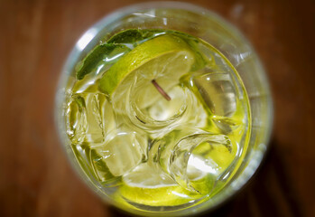 Mojito cocktail with ice, mint and lemon close-up top view