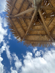 Tiki hut on a sandy tropical ocean beach vacation