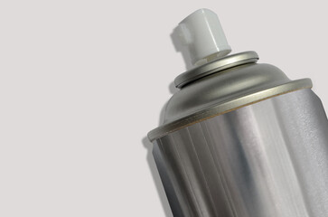 a tube of silver spray paint with copy space for text