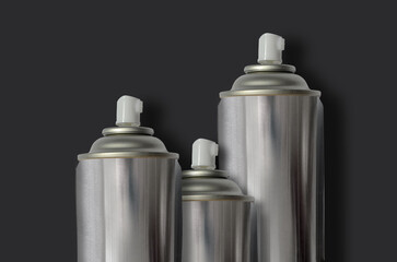 three tubes of silver spray paint on a black background.