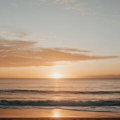 Obraz premium Stunning sunset view over a calm beach with golden skies and gentle waves. Ideal for travel, vacation, or relaxation themes. 