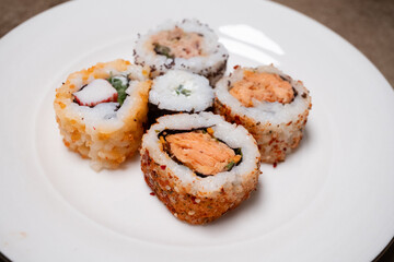 california roll sushi with chopsticks
