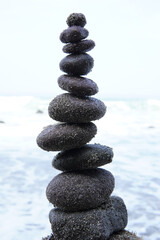 Balanced rock tower on the beach, Zen stones, peace and harmony, mindfulness concept