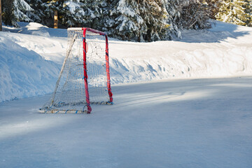 An ice hockey goal on a frozen lake in the mountains on the scratches surface abstract background...