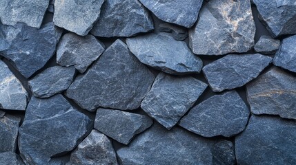 Fototapeta premium Textured dark granite surface with rough black and gray tones, forming a solid, rugged stone background on a plain surface 