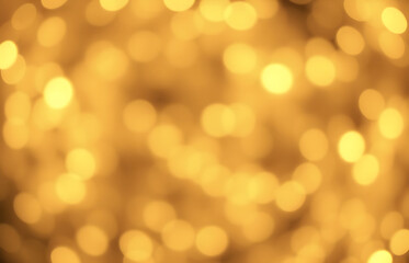 Fototapeta premium Golden Christmas background with abstract bokeh effect. Blurred glittering lights and sparkles create a luxurious atmosphere. Magical festive background with space for text, perfect for greeting cards