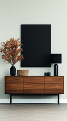 Minimalist living room decor with a black frame, wooden cabinet, and lamp.