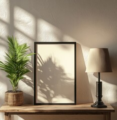 Side view mockup of a black frame on a wooden table with a potted plant and a table lamp