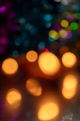 Abstract blurred warm bokeh lights against a dark background