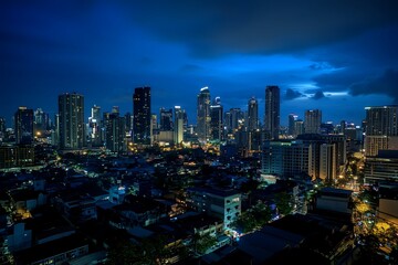Obraz premium Nighttime aerial perspective of Makati, the commercial hub of Metro Manila