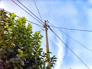 Old pole with wires against the sky. Electric transmission line. Eco-friendly energy