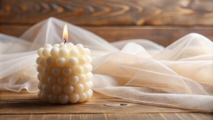 Handmade natural bubble candle on wood and tulle background in aromatherapy theme