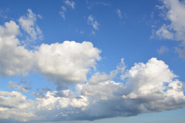 a group of white clouds that is in the blue sky banner 
