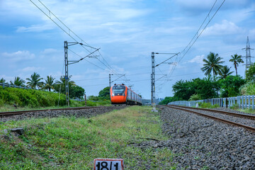 Saffron coloured Vande Bharat Express near Pune India. This is a tri-weekly train between Pune and...