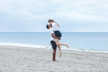 A couple enjoying a romantic moment on Zapillo beach in Almeria, Spain, capturing the joy of love by the tranquil sea