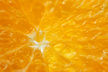 Macro photo of juicy orange pulp in a cut