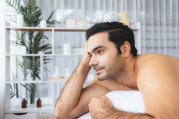 Caucasian man customer enjoying relaxing anti-stress spa massage and pampering with beauty skin...