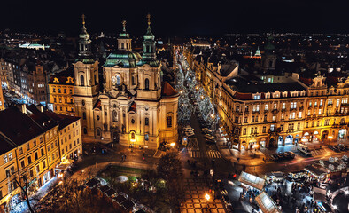 Obraz premium Christmas market on the Old town Square and the cathedral St. Nicholas- Prague, Czech Republic