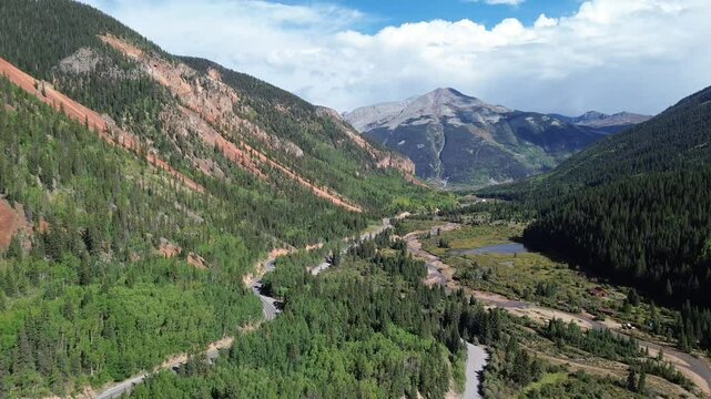 High alpine mountain view near Silverton, Colorado. Featured are the rich, red rock of the mountains as the flight goes down the valley.