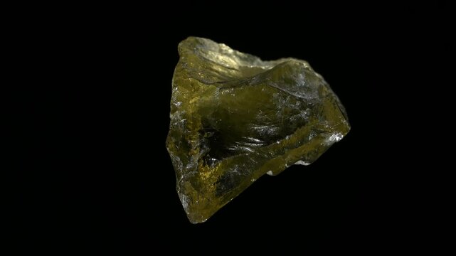 Citrine (yellow quartz) sample rotating against a black background.