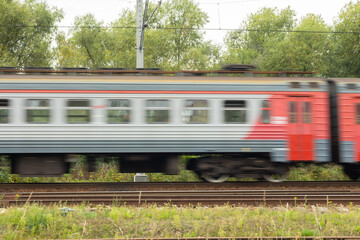 Fototapeta premium departing passenger train in motion with blur effect
