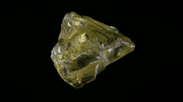 Citrine (yellow quartz) sample rotating against a black background.