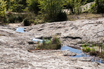 Rocky landscape with a small drying up creek in mountain 