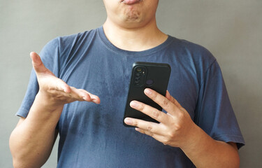 Portrait of asian man hold smartphone on using two hand
