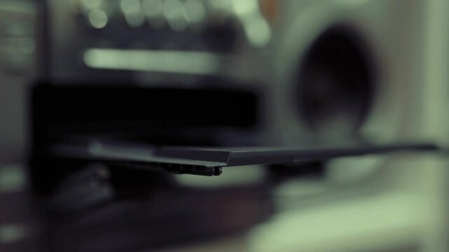 Close up of cd discs in an old musical center. Technology concept.