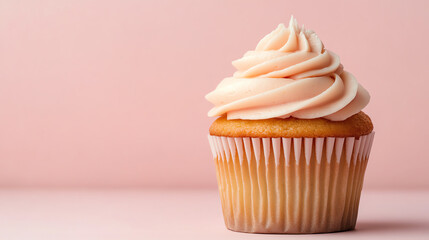 Delicious vanilla cupcake topped with creamy pink frosting, placed on a soft pink background, perfect for dessert lovers and baking enthusiasts.
