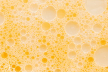 Texture of fat or oil with yellow bubbles. Background of fat bubbles