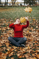 woman sitting on the leaves