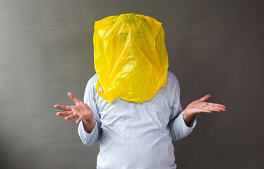 Handsome asian use a plastic bag to cover his face. Save the environment from plastic pollution...