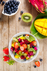 delicious exotic fruit salad with dragon fruit, mango, banana and blueberry