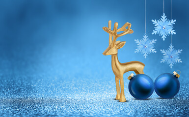 Gold deer, Christmas bauble and snowflake on shiny glitter blue background with bokeh light. Festive winter holiday decoration and ornament. Modern design with copy space for card, banner, invitation