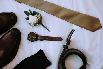 Groom wedding accessories. shoes, belt, watch, tie and corsage on white background. 