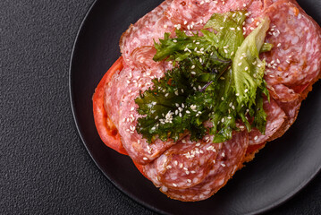 Focaccia with salami, cheese, tomatoes, arugula, salt, spices and herbs