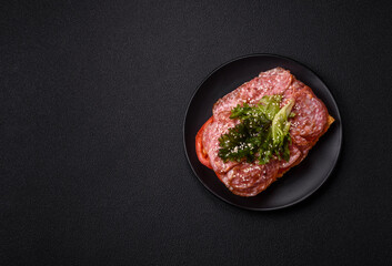 Focaccia with salami, cheese, tomatoes, arugula, salt, spices and herbs