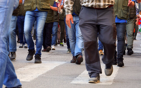 people are marching peacefully in the street during a protest and strike to demand better wages for workers